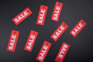 Red sale tags on a black background. Ideal for marketing and promotional use.